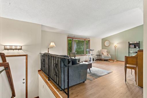 Main level living room with vaulted ceilings and newer flooring!
