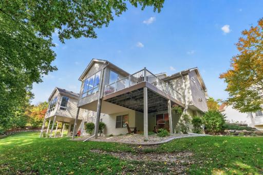 Elevated deck showcases the wooded backdrop.
