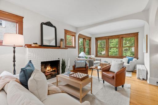 Living room centered on a gas fireplace with original oak woodwork
