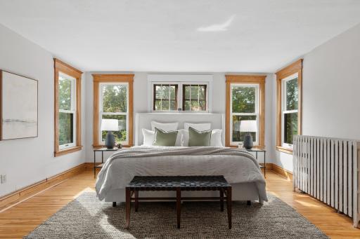 14x17 primary bedroom with a private three-quarter bath and two closets