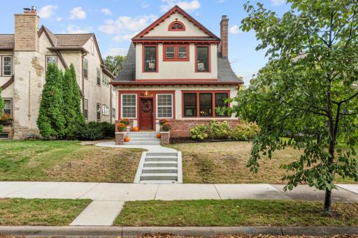 Stucco-and-brick exterior with new concrete front steps and sidewalk