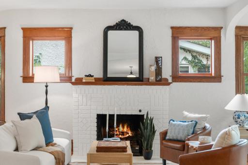 Gas fireplace with painted brick surround and wood mantel
