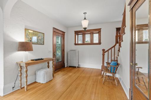 Foyer with original woodwork, staircase and hardwood floors