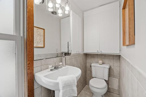 Primary three-quarter bath with new light fixtures