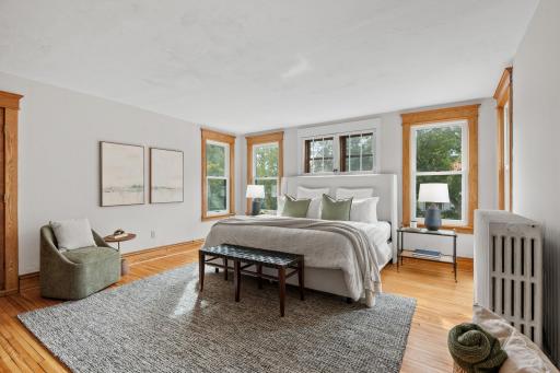Spacious primary bedroom suite with hardwood floors