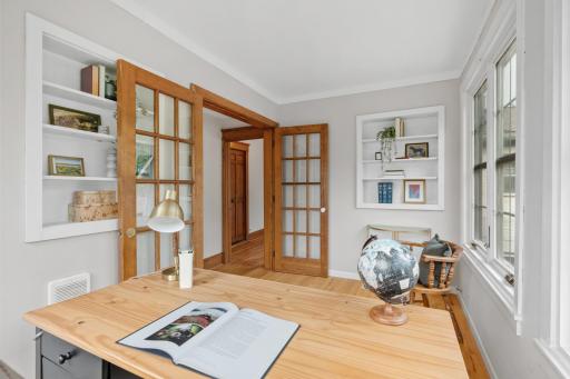 Office with French doors and built-in shelving