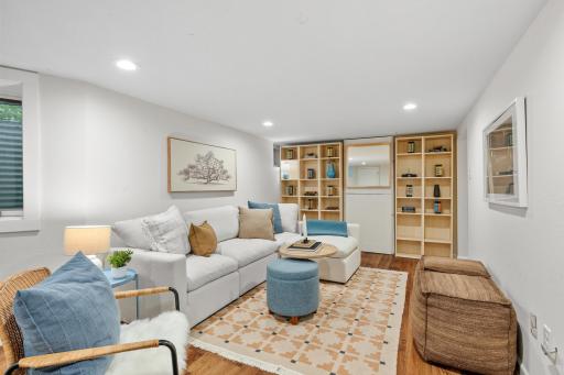 Lower-level family room with built-in bookshelves - could be a fifth bedroom suite