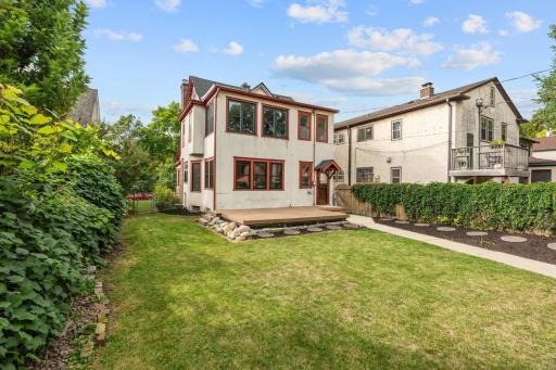 Fenced, landscaped backyard with open lawn