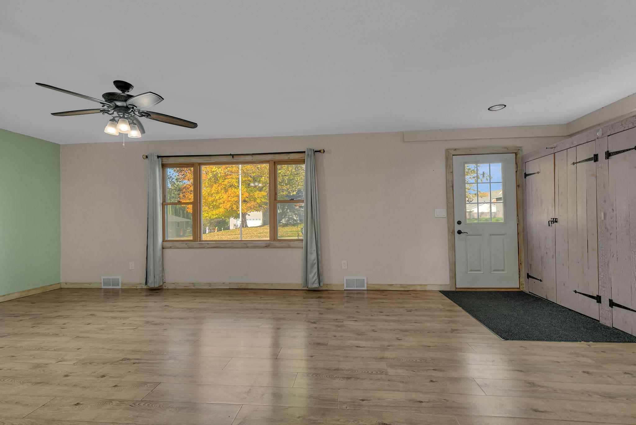 Living room space with large window offers lots of natural