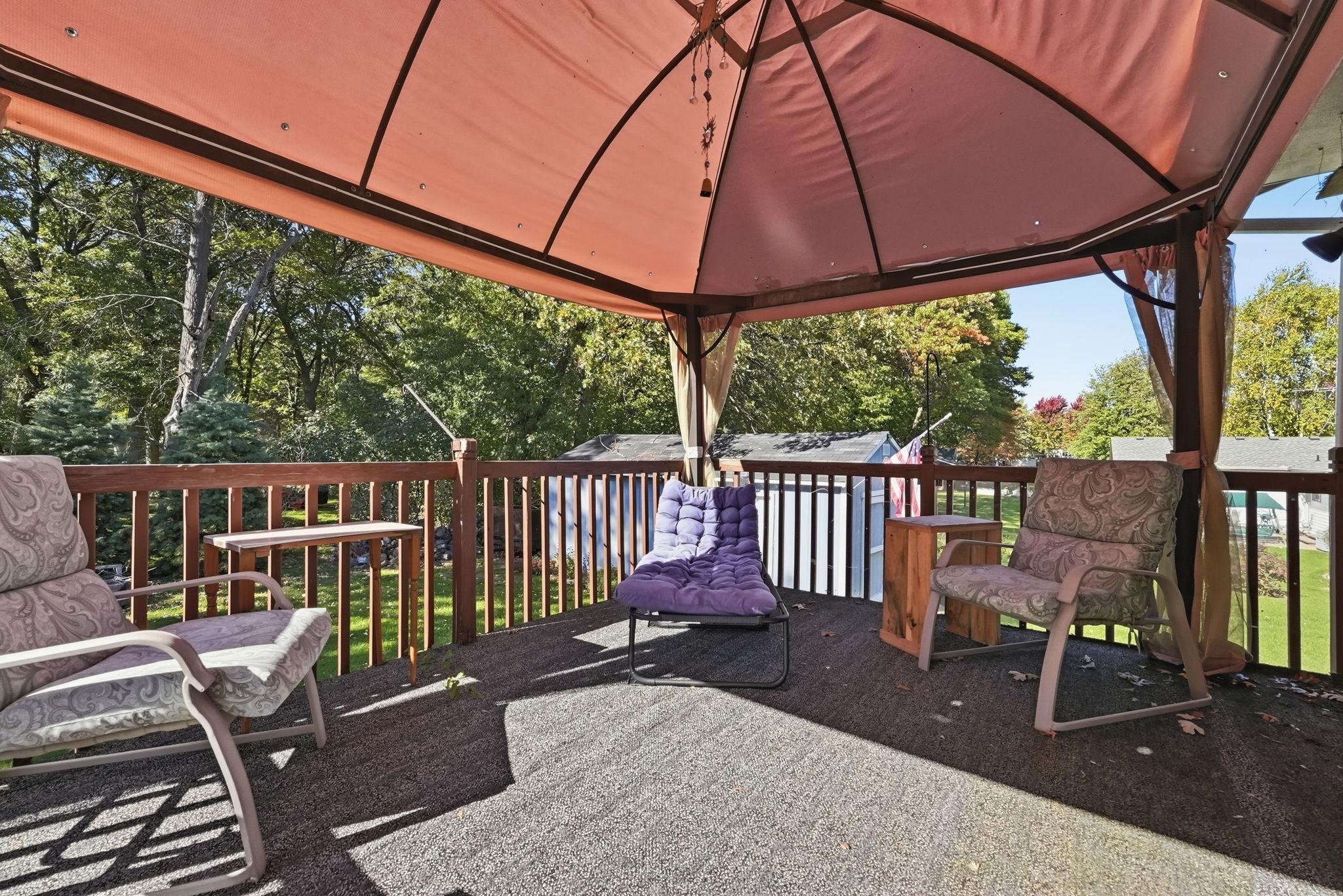 Covered deck overlooks the backyard.