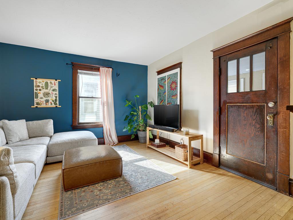 The main-level family room showcases beautiful hardwood floors and timeless woodwork, adding warmth and character to this inviting living space.