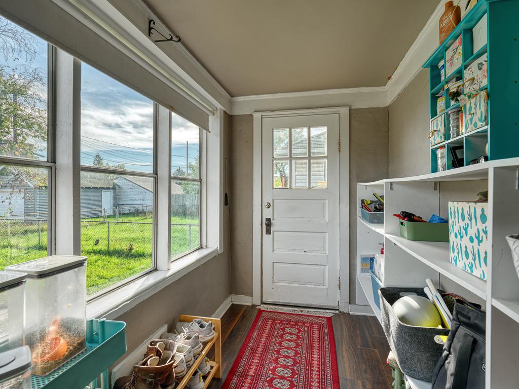 Entering from the backyard and garage, you will find a large and convenient mudroom with shelves and space to store your outdoor gear or additional kitchen storage space. l