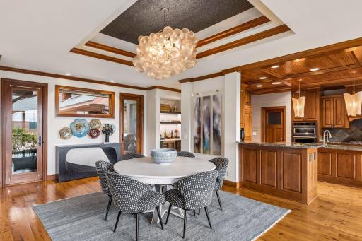 A custom tray ceiling, designer chandelier, and built-in bar set the stage for elegant dining, with St. Croix views just beyond