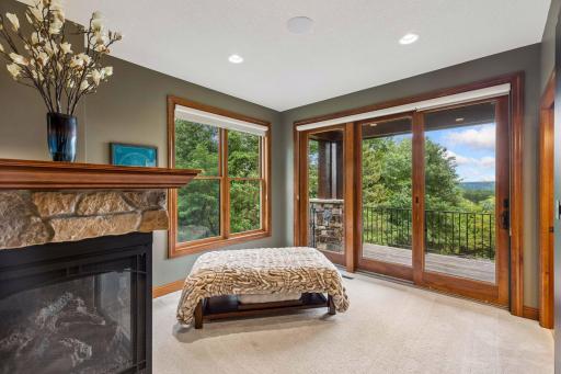 Sliding doors in the sitting area open to a private deck with treetop and valley views
