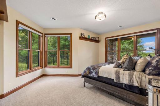 Private guest suite with a full bath, surrounded by treetops and natural light