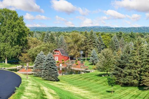 Historic Civil War era barn and private pond, framed by evergreens and rolling St. Croix Valley hills