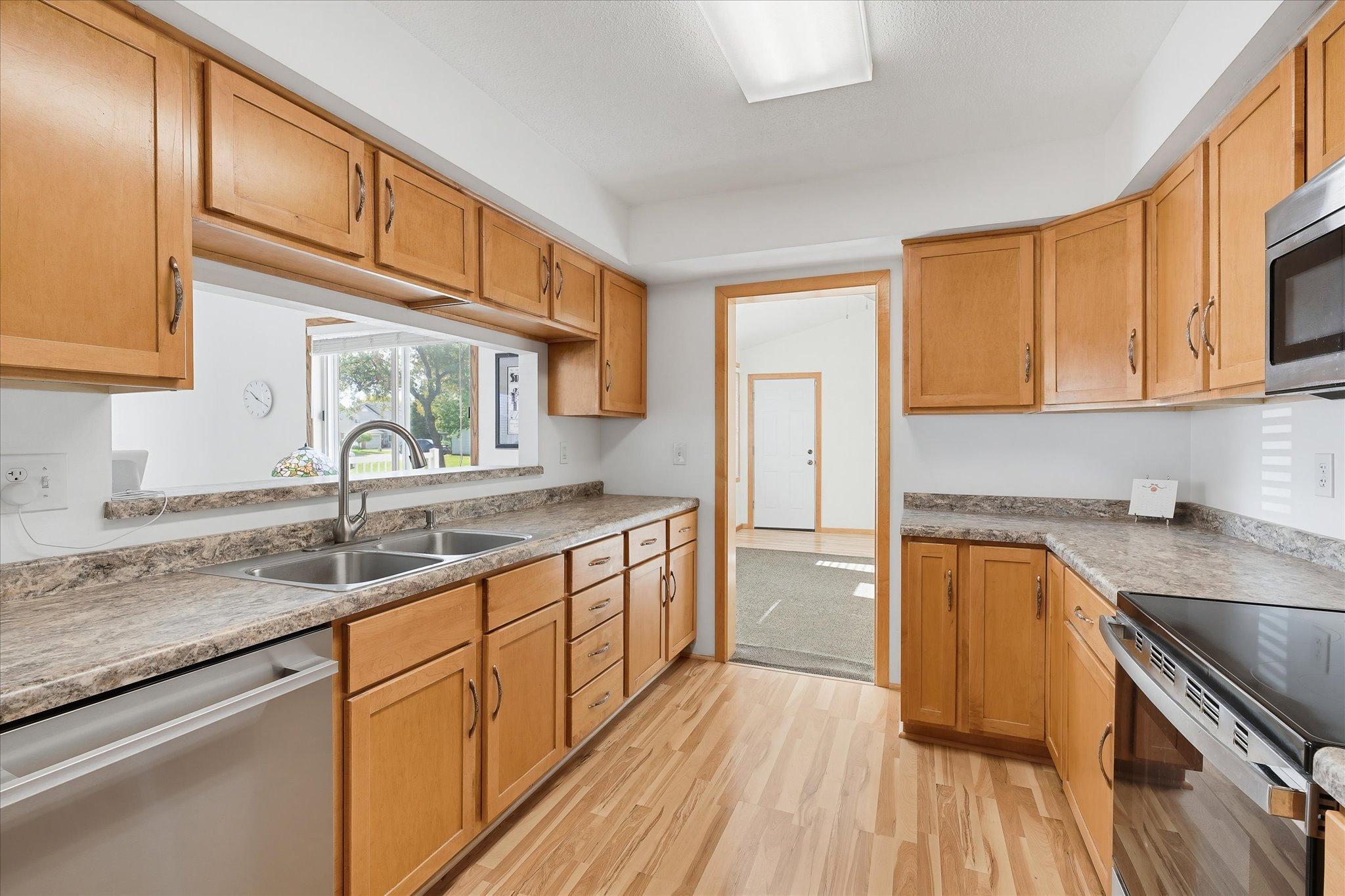 Angle that shows the views when you are using the sink, a lot of natural lighting comes through with the windows in the dining area.