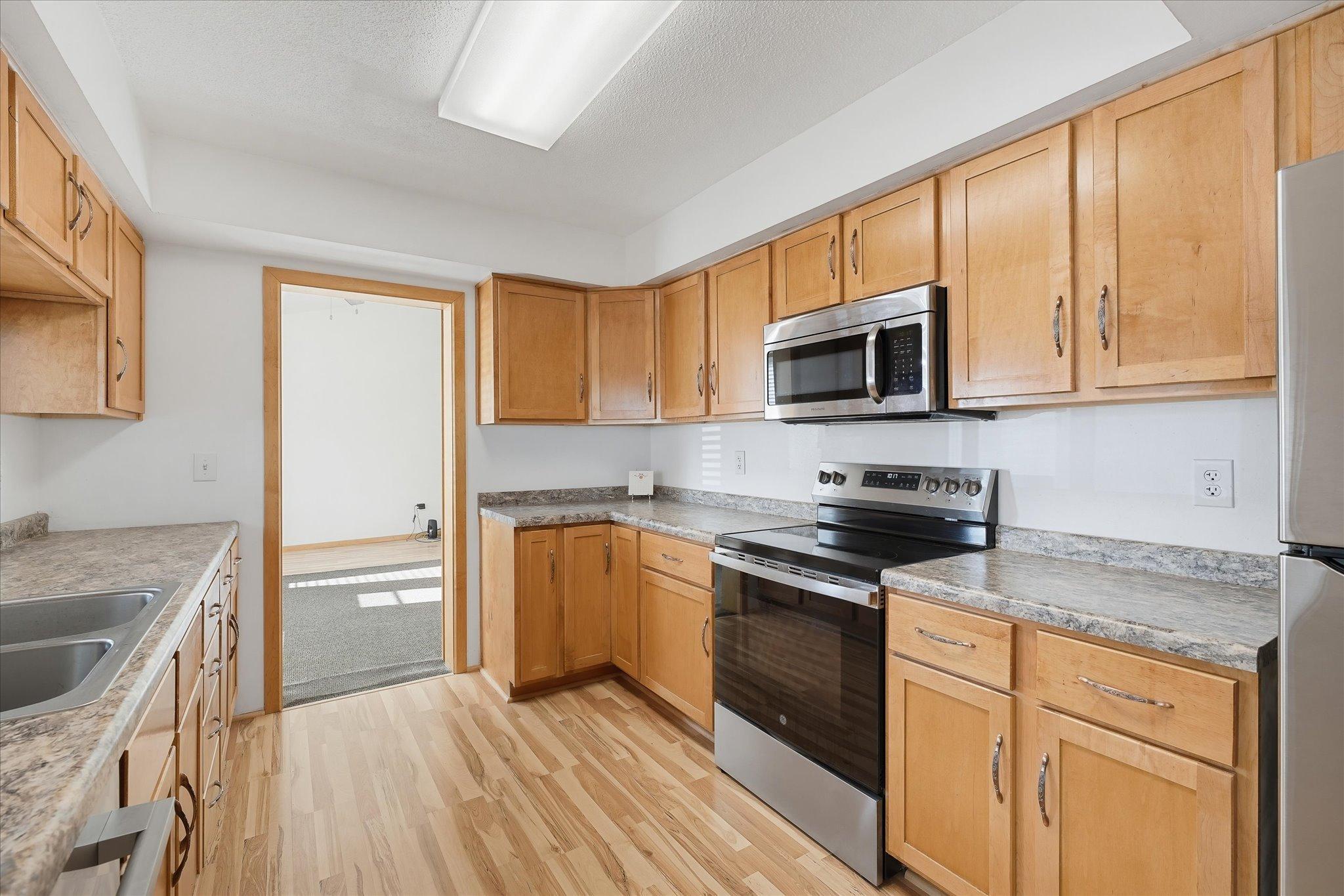 A lot of counter top space in your kitchen. Nice cabinets as well.