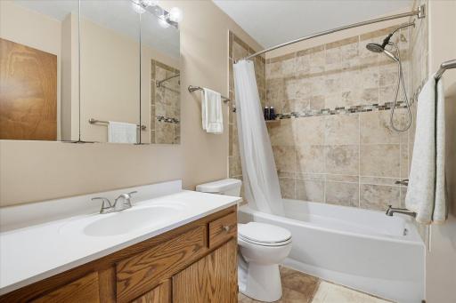 Full bathroom on the upper level that has a shower that is beautifully tiled.