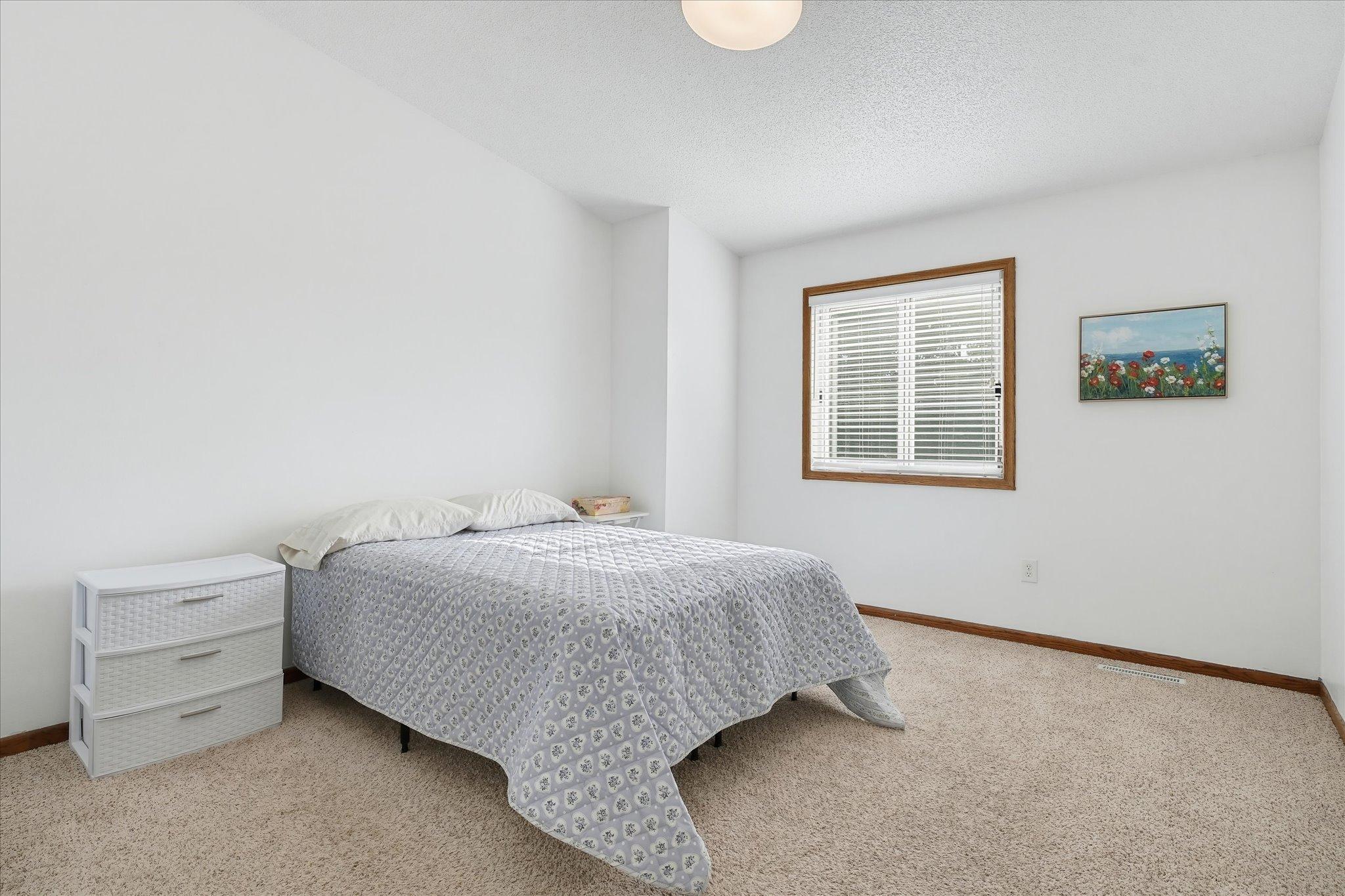 Primary bedroom on the upper level that has a walk-in closet.