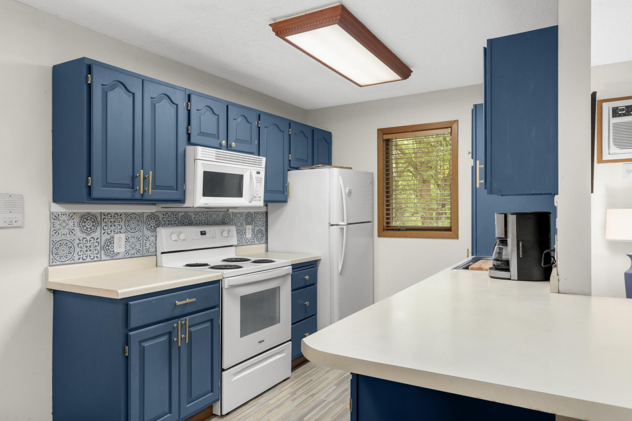 Painted cabinets and updated hardware give the kitchen a fresh, modern feel.
