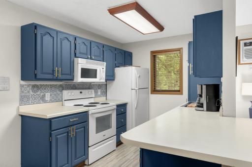 Painted cabinets and updated hardware give the kitchen a fresh, modern feel.