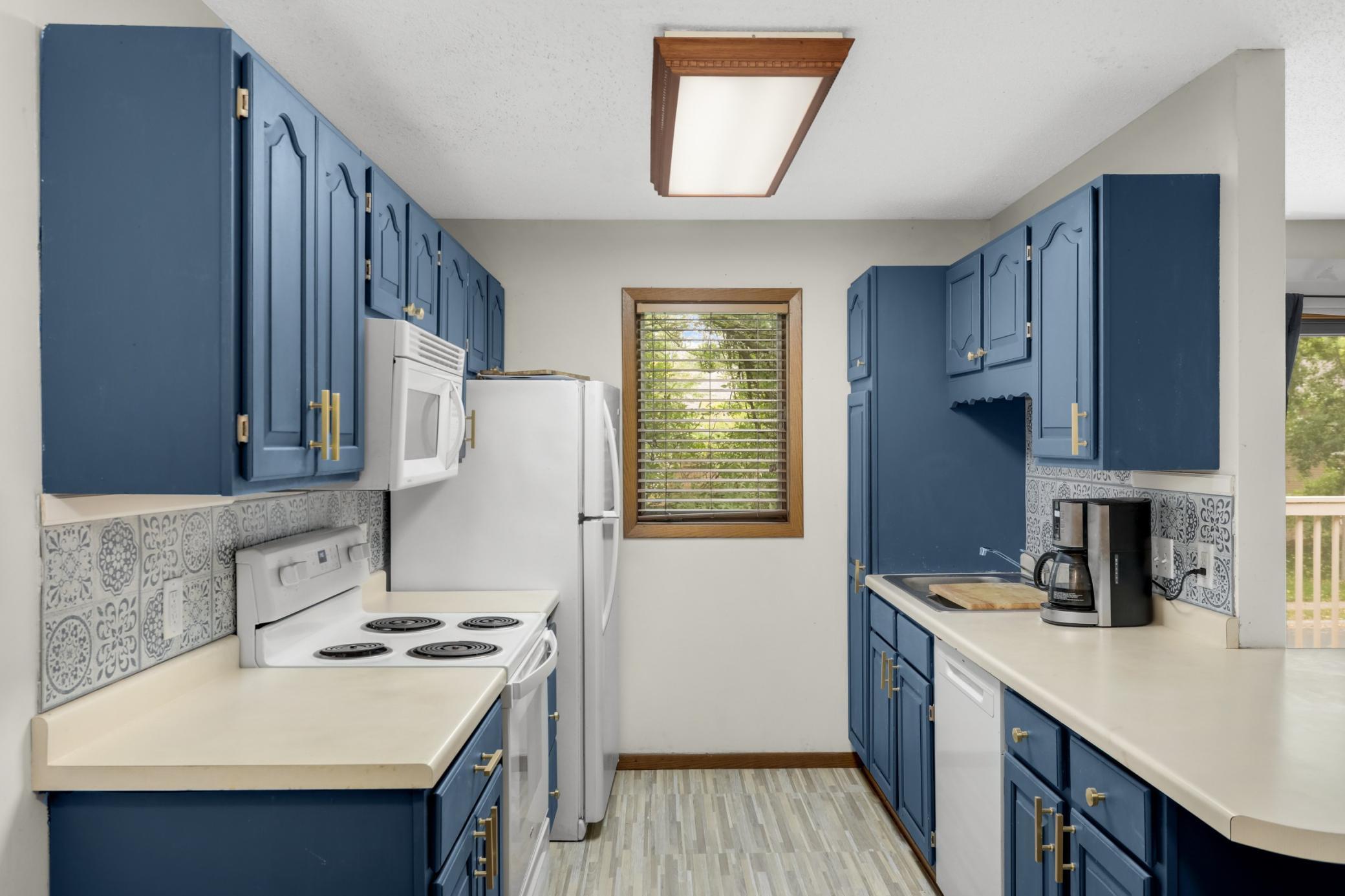 Well-appointed kitchen with a range, dishwasher, and ample cabinet space.