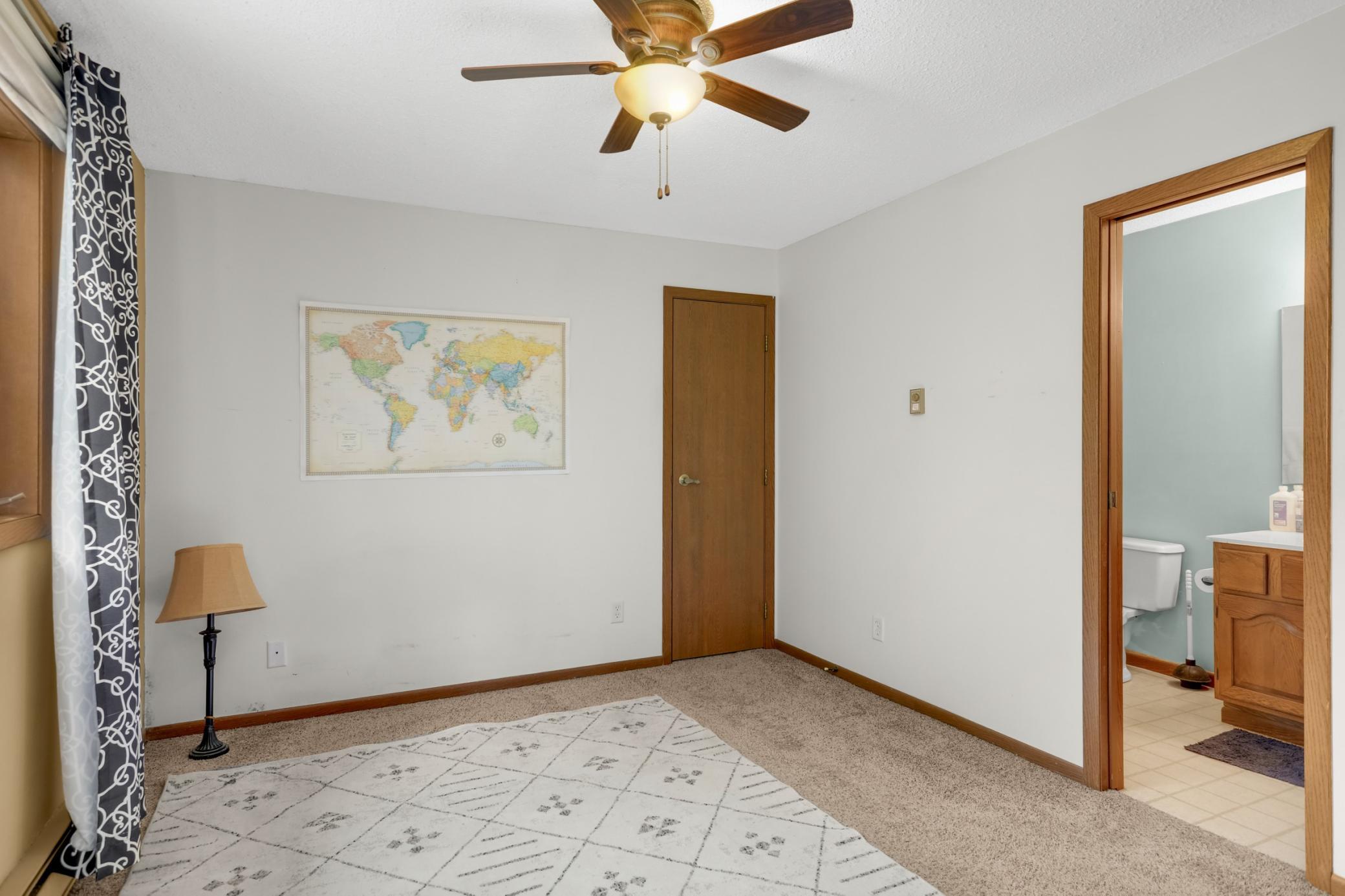 Spacious second bedroom featuring a generous walk-in closet and convenient access to the second bathroom.