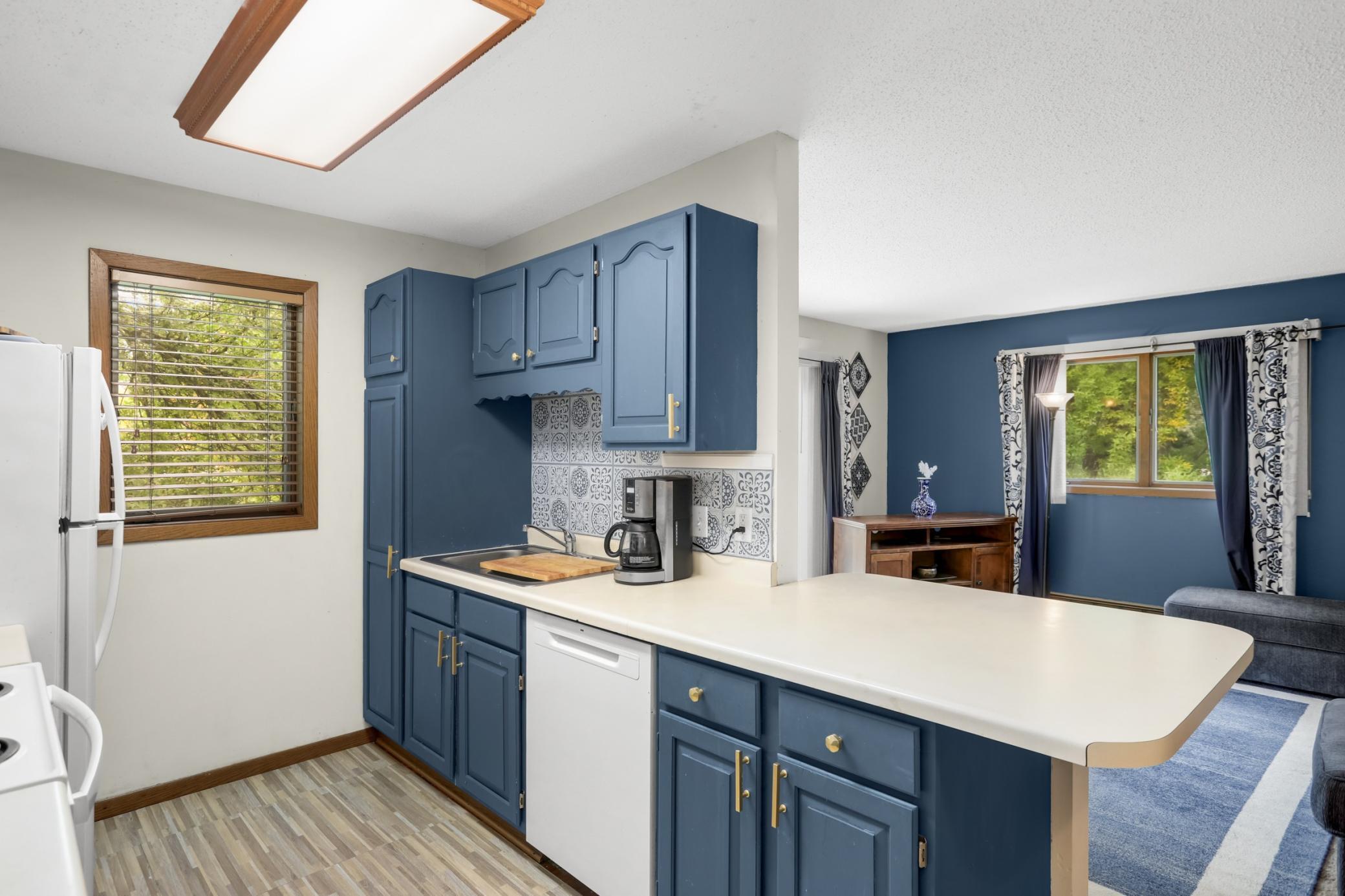 A beautiful backsplash and newer laminate flooring add a polished touch to the space.