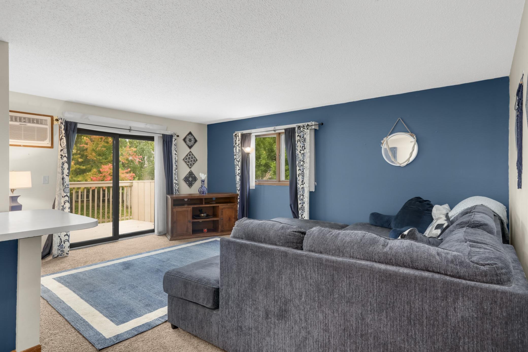 A gorgeous accent wall adds a beautiful pop of color to the living room.
