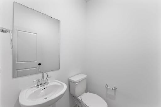 Right off the foyer is a convenient powder room to accommodate the needs of the whole family and visiting guests alike.