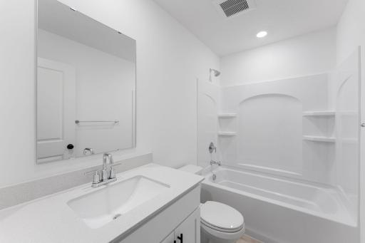 A full bathroom on the second floor comes well-equipped with a stylish vanity and a combination shower and tub.