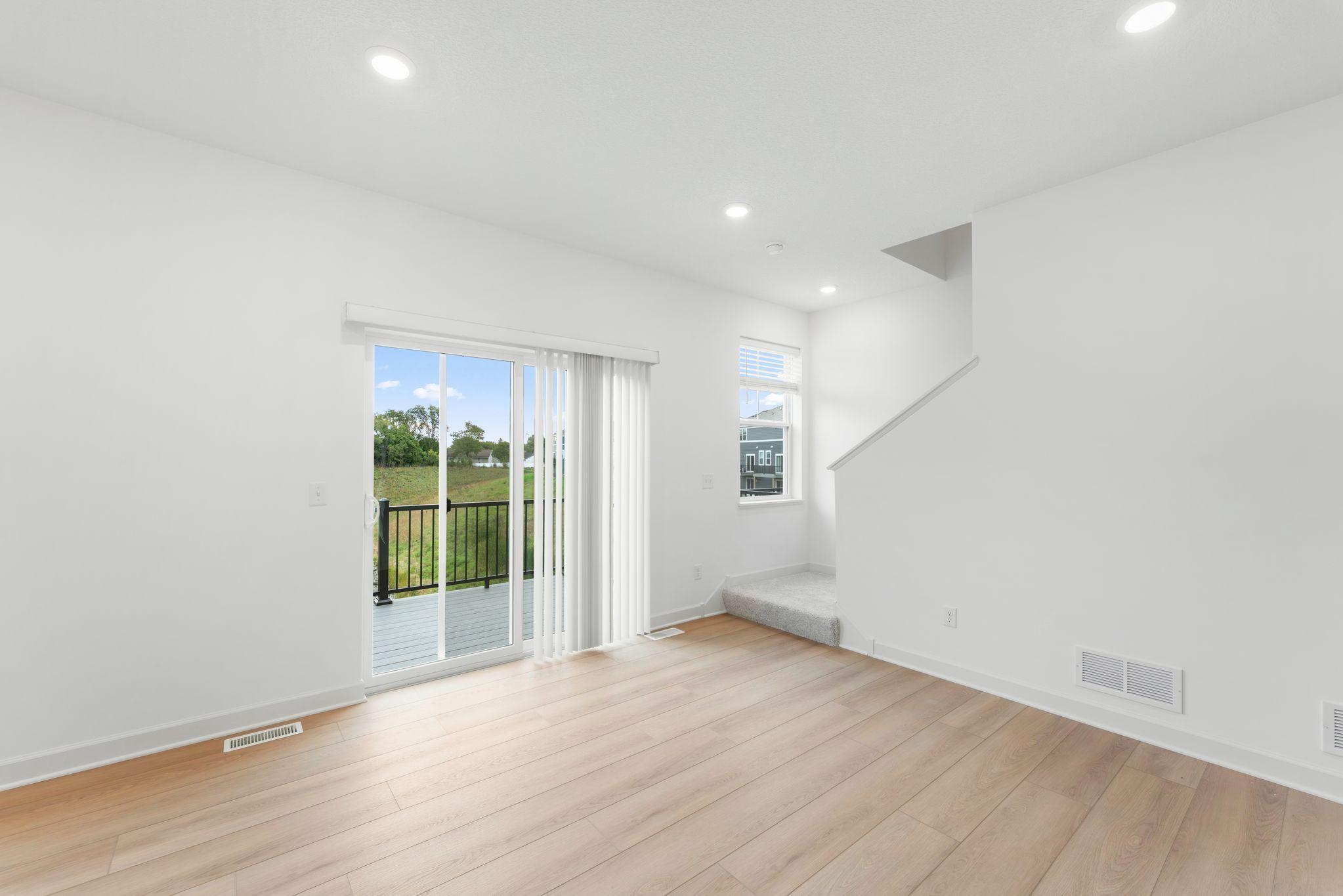 Natural light streams in from glass sliders onto the dining area, setting the scene for daily meals with family and friends.