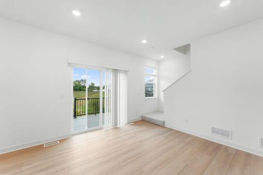 Natural light streams in from glass sliders onto the dining area, setting the scene for daily meals with family and friends.
