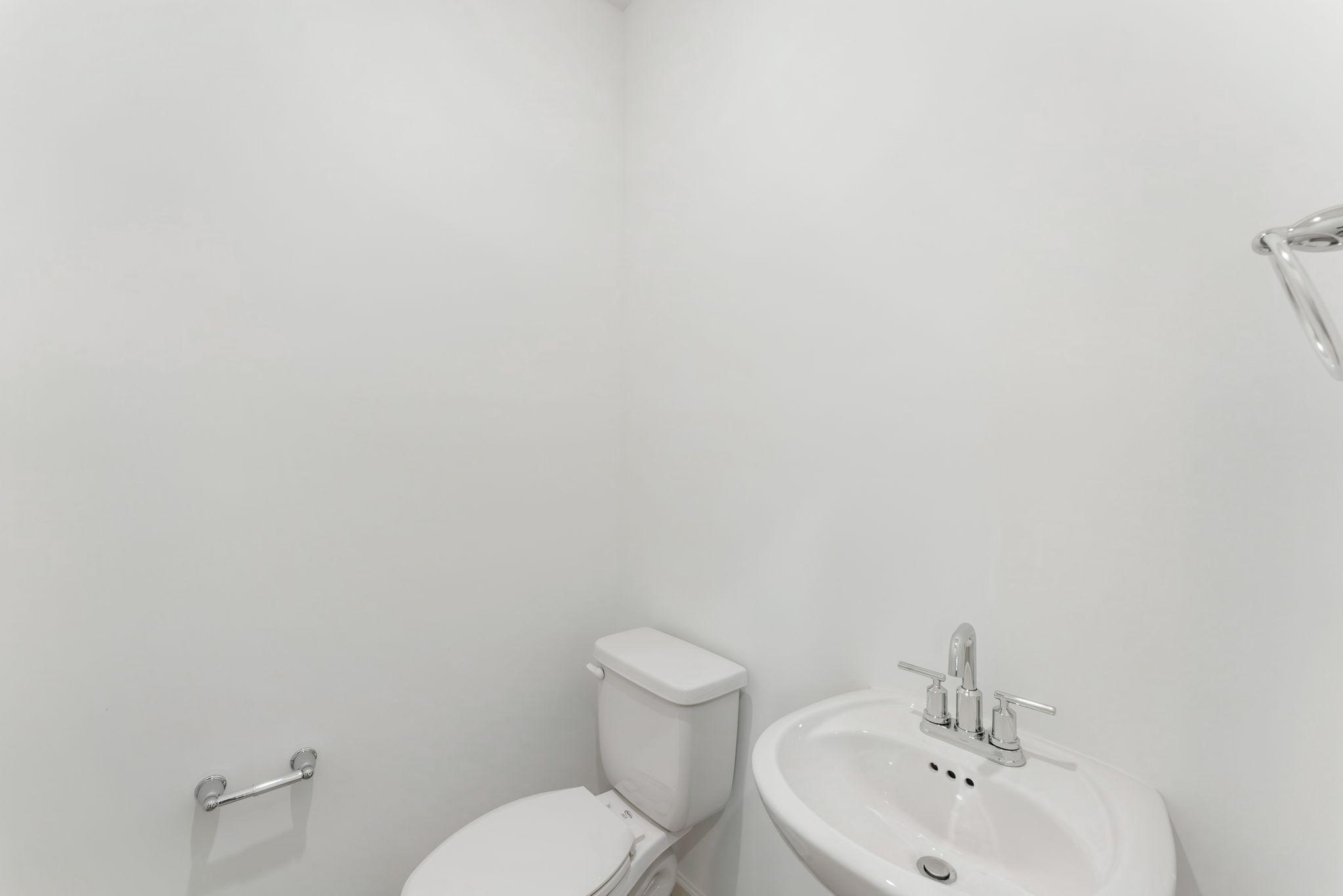 Right off the foyer is a convenient powder room to accommodate the needs of the whole family and visiting guests alike.