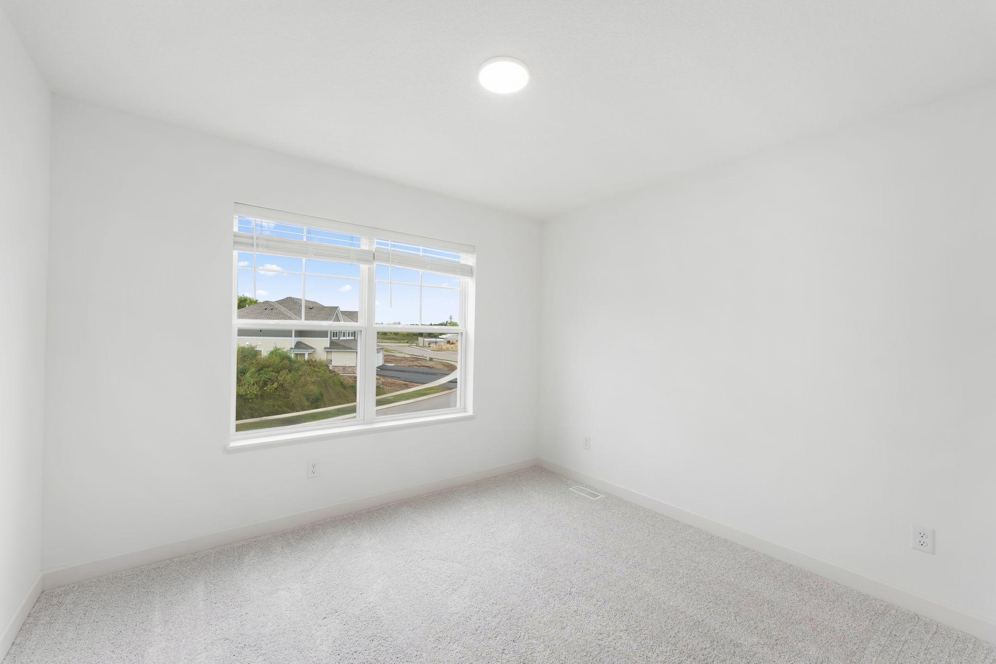 Situated down the hallway from the owner’s suite are two secondary bedrooms. Both include practical closet space and plush wall-to-wall carpeting.