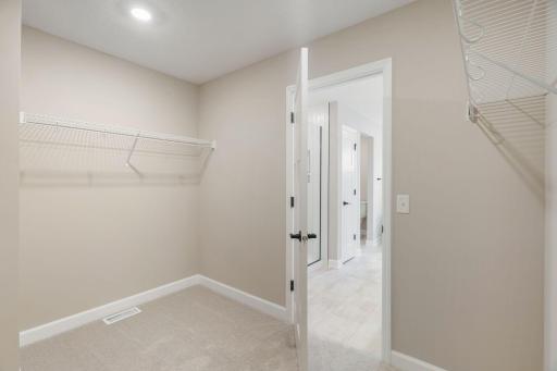 The walk-in closet is easily accessible through the bathroom