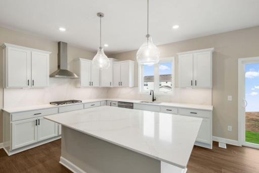 The focal point of this modern kitchen is an inviting center island that provides additional counter and seating space. It is surrounded by ample cabinetry and all-new stainless steel appliances
