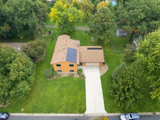 Aerial view of home and yard. Notice the solar panels installed in 2025, fully paid for and insured for 30 years and transferable to the new homeowner.