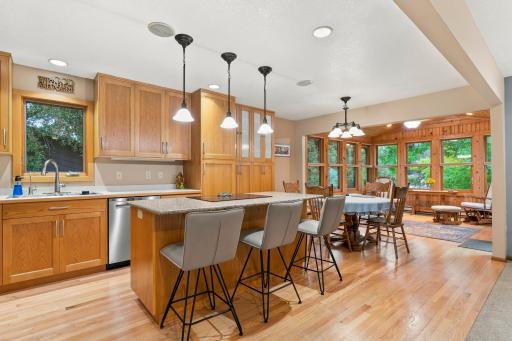 The center island breakfast bar has a Cambria countertop, along with an electric cooktop and oven.