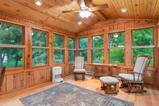 Gorgeous south-facing 4-season porch with knotty pine walls and vaulted ceiling.