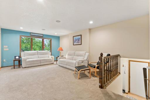 Living room showing the open railing down to the front entry.