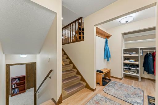 The front foyer has been expanded for more room and storage space, making it a welcoming foyer/mudroom. Note the luxury vinyl planking