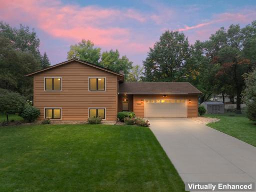 Beautifully landscaped and a concrete driveway.