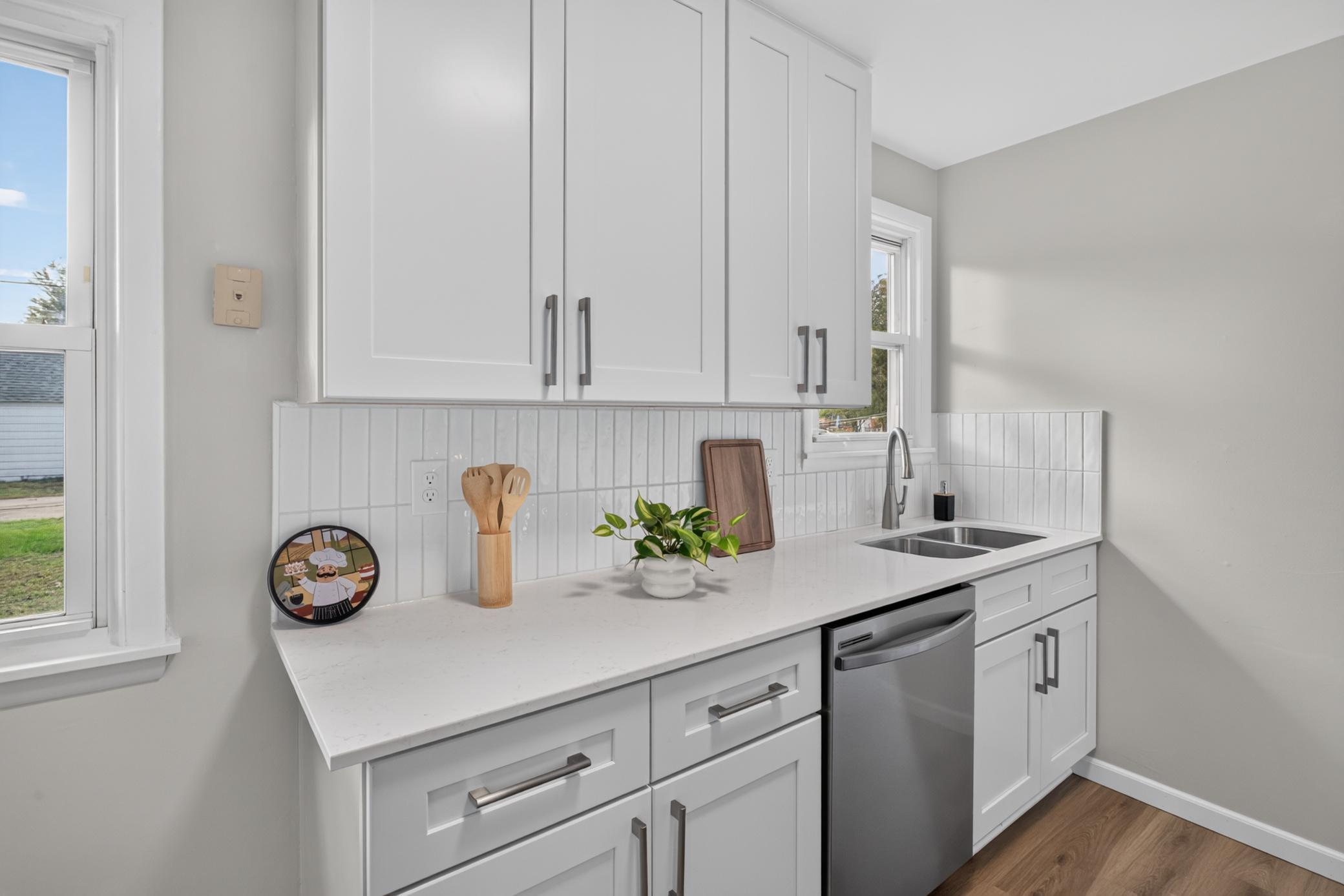 New cabinets, countertops, tile back splash and stainless steel appliances