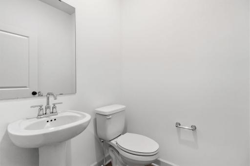 Right off the foyer is a convenient powder room to accommodate the needs of the whole family and visiting guests alike.