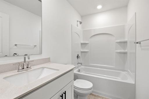 A full bathroom on the second floor comes well-equipped with a stylish vanity and a combination shower and tub.