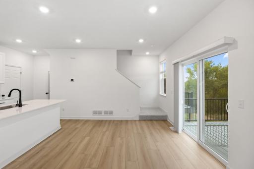 Natural light streams in from glass sliders onto the dining area, setting the scene for daily meals with family and friends.