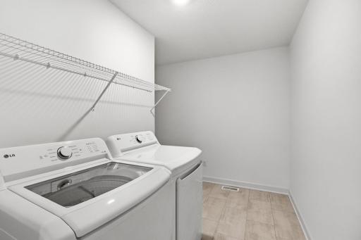 This spacious laundry room is located on the same level as the bedrooms in a thoughtful design to get weekly chores done in a snap.