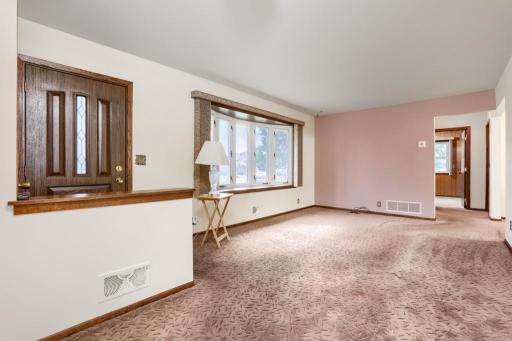 Formal Living Room with Bay Window. Hardwood floors under the carpet. Condition unknown.